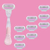 A collection of pink and white shaving blades, including a handle and multiple replacement heads.