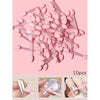 A pile of pink double-sided nail art brushes with sponge applicators shown against a light pink background.