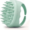 A light green scalp massager shampoo brush with soft silicone bristles shown from the side.