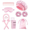 Un ensemble d'outils de coiffure roses comprenant un peigne, des lunettes, des rouleaux pour cheveux et un sac pour cheveux e