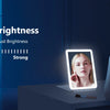 A woman holds an adjustable brightness LED makeup mirror, demonstrating its light settings.