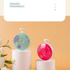 Two electric baby nail trimmers, one teal and one pink, are displayed on white stands.