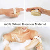Hands holding a natural bristle body brush with a light beige strap, showing its texture and use for exfoliation.