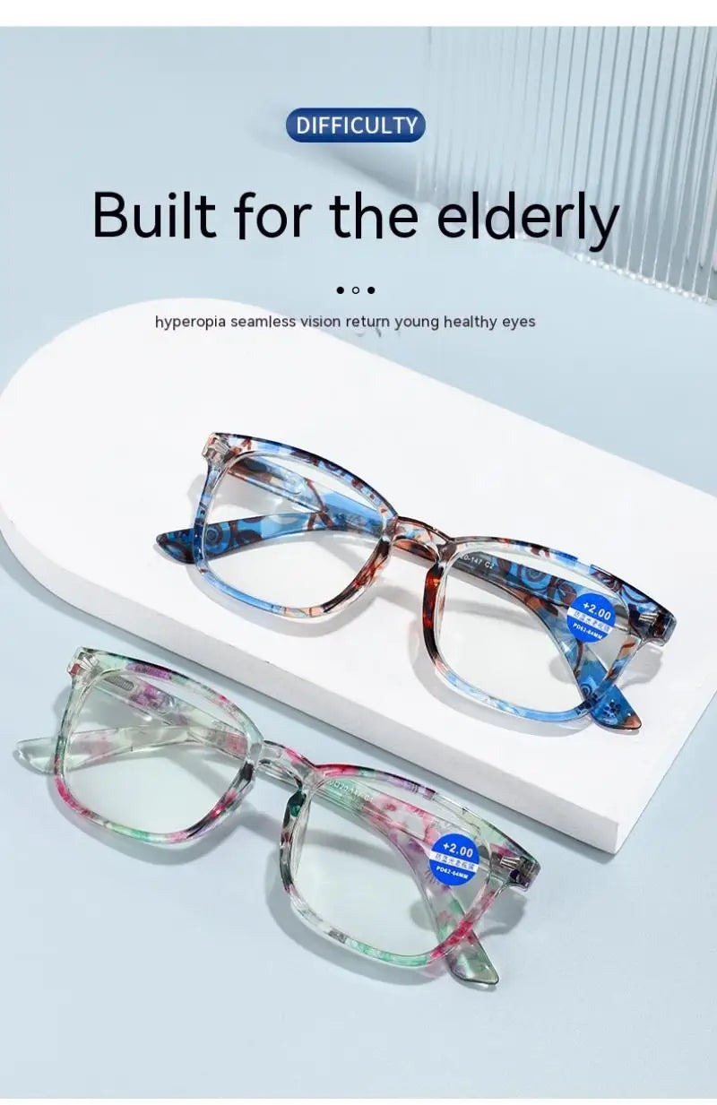 A pair of blue and purple framed reading glasses displayed on a white background.