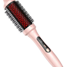 A pink infrared heated round brush with black bristles is shown in a close-up view.