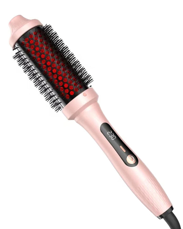A pink infrared heated round brush with black bristles is shown in a close-up view.