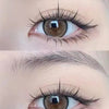 Close-up of an eye showing natural look brown eyelash clusters applied to the upper lash line.