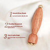 A wooden gua sha tool with smooth brass beads, featuring an easy-to-grip shape for facial massage.