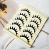 A square plastic tray holds five pairs of long and thick black false eyelashes for eye makeup.