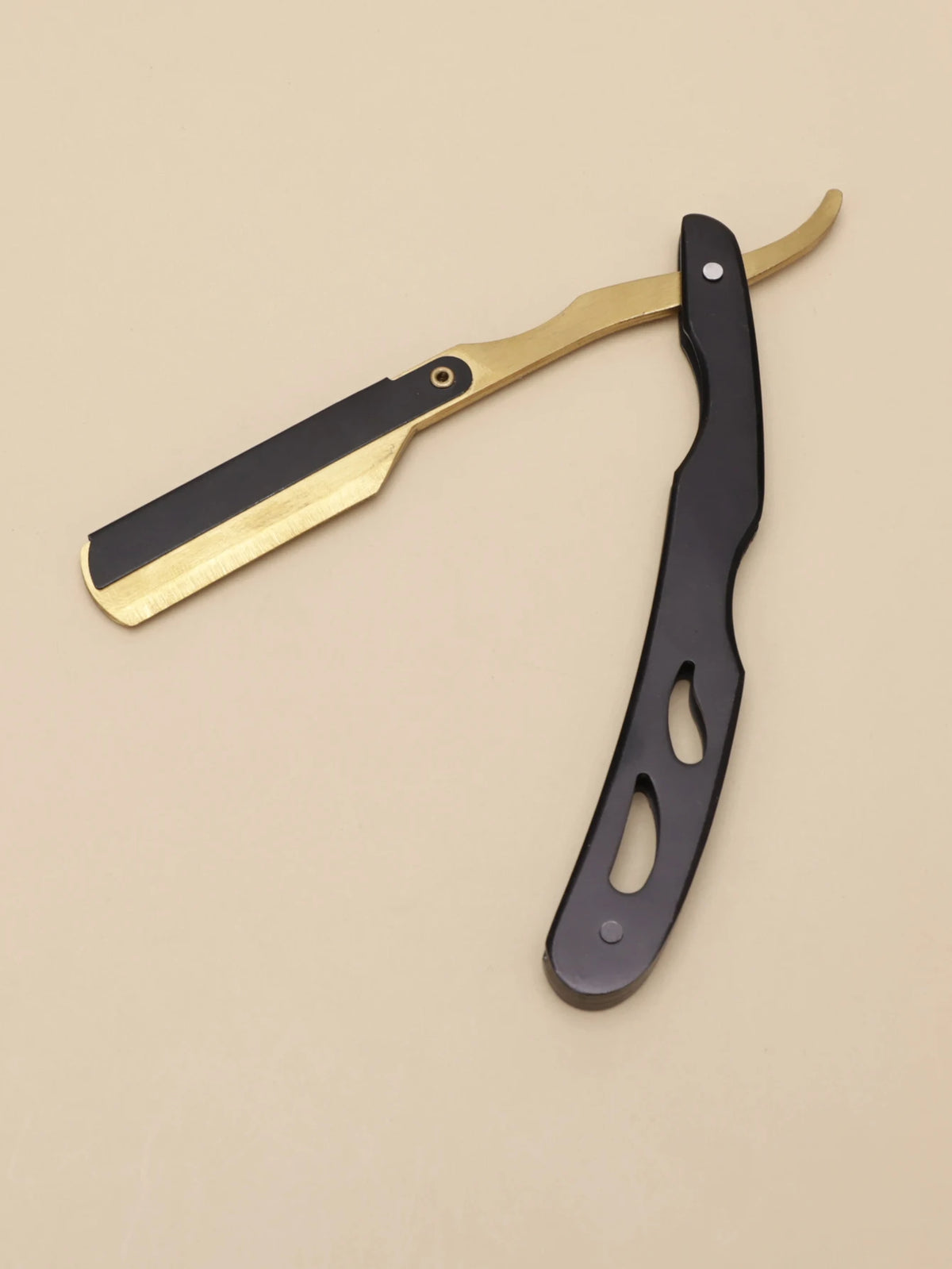 A professional stainless steel shaver and beard razor kit with a gold handle and black blade.