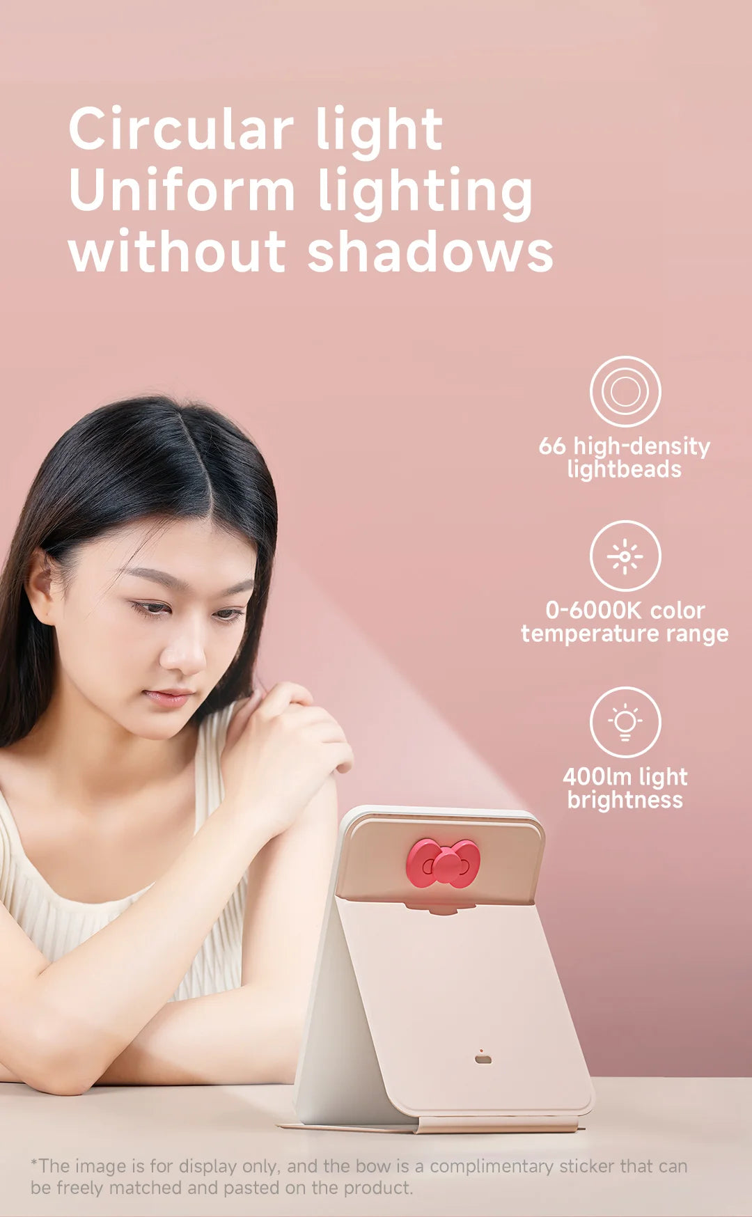 A woman is looking at a foldable LED makeup mirror with a pink casing and a red accent, demonstrating uniform lighting.