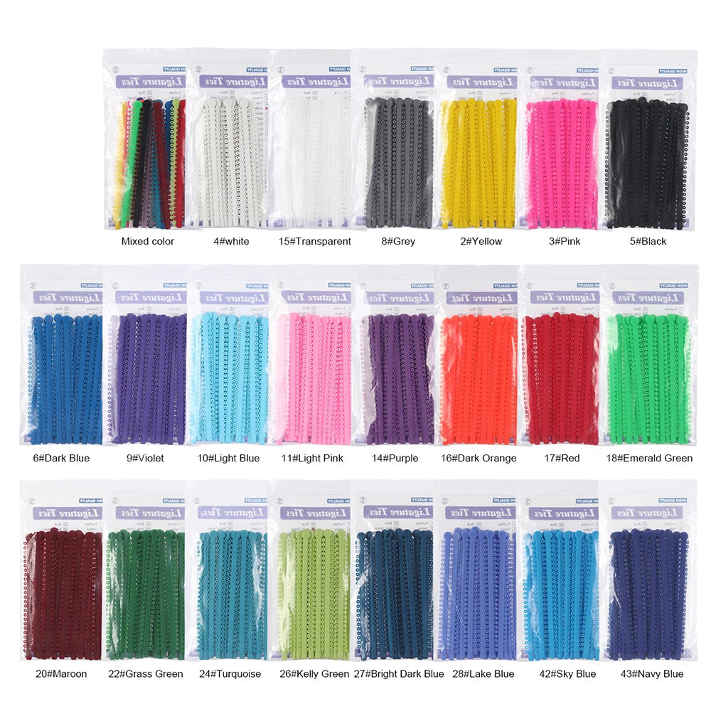 A collection of dental orthodontic elastic ligature ties in various colors including white, grey, yellow, pink, black, blue, 