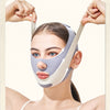 A woman is wearing a gray V-Line face sculpting and slimming strap on her face.
