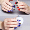 A hand displays various acrylic nail tips and glitter powders arranged for a beginner's nail kit.