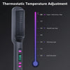 A close-up view of a black electric hair straightener comb with a temperature adjustment scale.