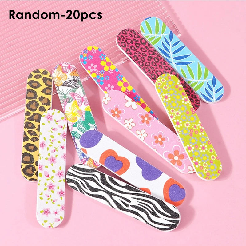 A collection of 20 random double-sided nail files and buffing blocks in various colorful patterns on a pink background.