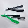 A set of black and green folding shaving razors, including a safety razor and a straight razor.