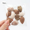A hand holds a clear plastic bag containing 10 reusable expandable makeup sponges in various natural and earthy tones.