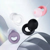 A collection of pink, white, and black silicone earplugs shown in various angles against a light gray background.