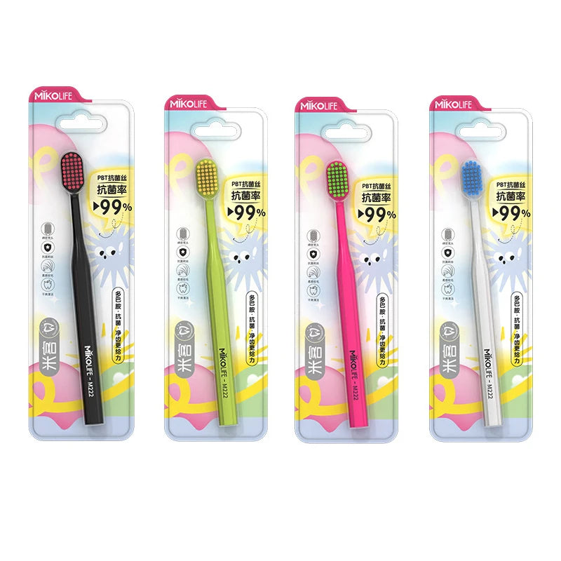 Four packages of pink and green soft bristle manual toothbrushes for adults with 99% brush performance guarantee