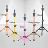 A collection of adjustable wig stands in orange, yellow, black, dirty orange, and pink, displayed against a white background.