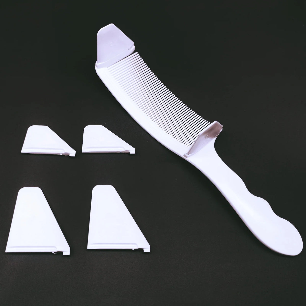A white professional flat top hair cutting comb set with multiple interchangeable combs displayed on a dark background.