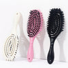 Three styling combs: a white spiral comb, a pink comb, and a black comb.
