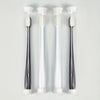 Three clear tubes of ultra-soft microbristle toothbrushes with white handles displayed vertically.
