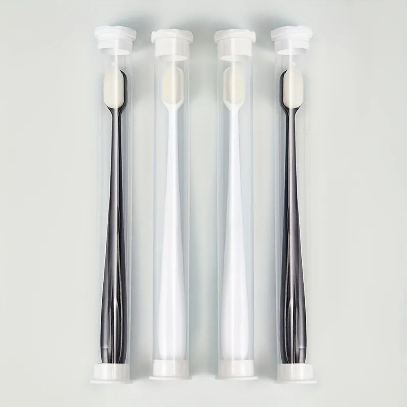 Three clear tubes of ultra-soft microbristle toothbrushes with white handles displayed vertically.