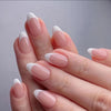 A close-up of a hand displaying glossy pink and white almond shaped press-on nails.