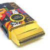A close-up of a gold hair clipper replacement blade set with colorful graphics and a textured metal blade.