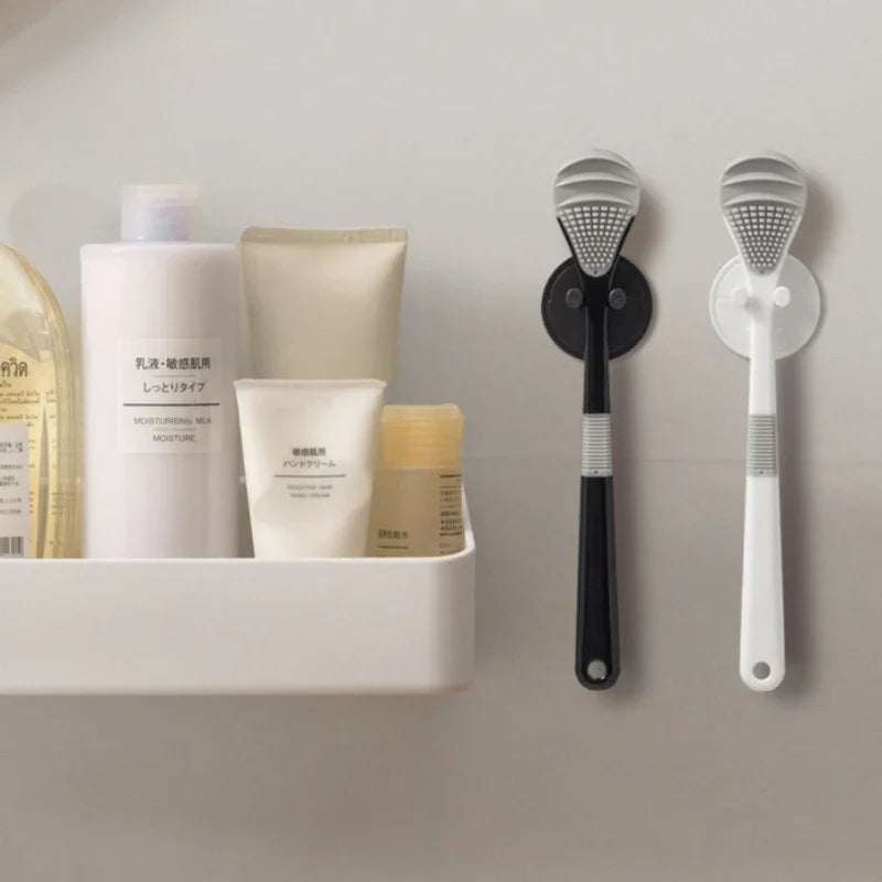 A white bottle of moisturizing sea salt and a beige tube of moisture are displayed next to two reusable tongue cleaner brushe