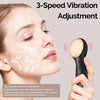 A woman is using a black vibrating facial cleansing brush on her face for skin treatment.