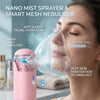 A woman is using a pink nano mist sprayer and smart mesh nebulizer for facial hydration.