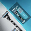 A Gillette Deep Shave Hard Stubble razor and multiple blades displayed on a light blue background.