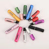 A collection of portable refillable perfume bottles in various colors arranged in a circular pattern.