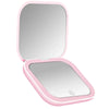 Miroir de vanité pliable rose avec couvercle ouvert et lumière LED intégrée.