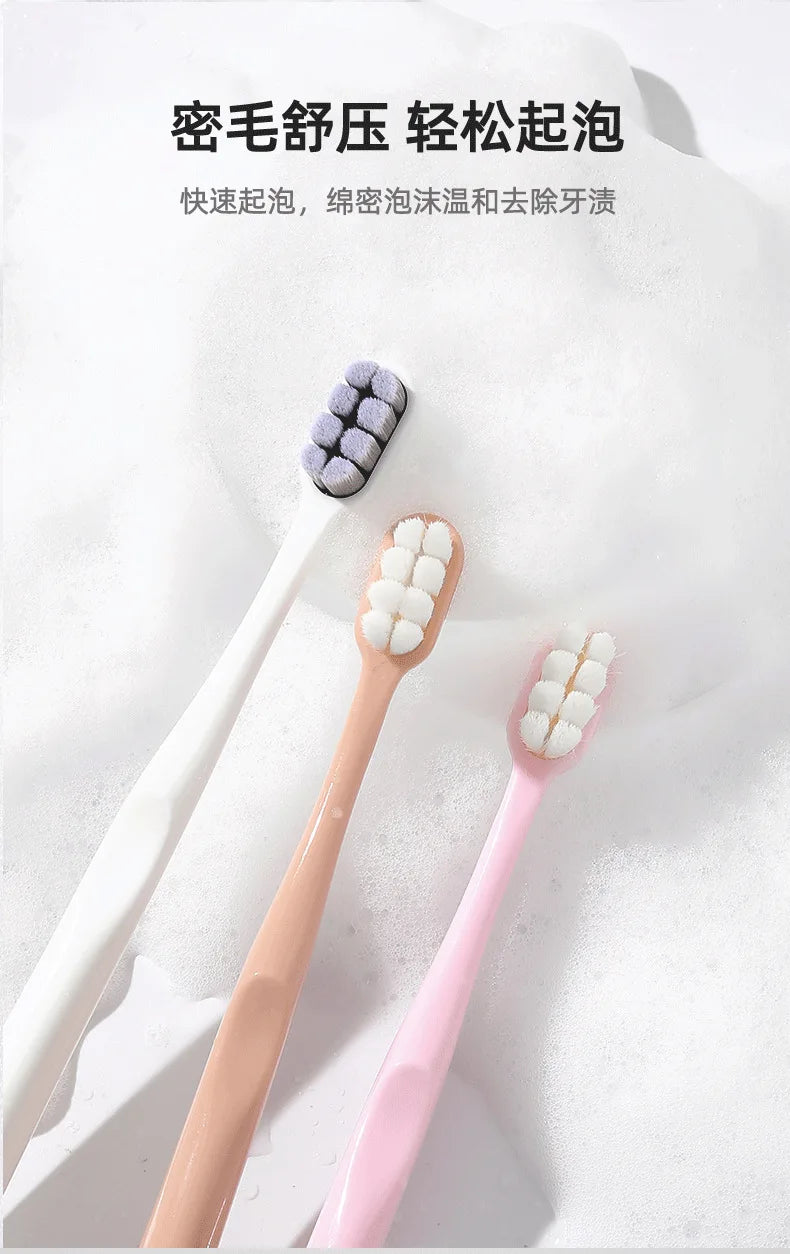 A set of soft bristled toothbrushes in purple and pink colors shown against a white background.