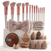 A set of various beauty sponges and applicators in shades of pink, brown, and beige displayed on a white surface.