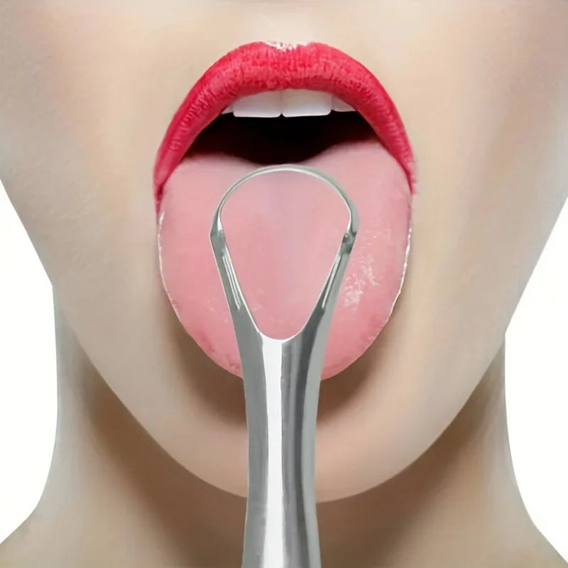 A close-up of a person's mouth showing the tongue and upper lip, with a stainless steel tongue scraper visible.