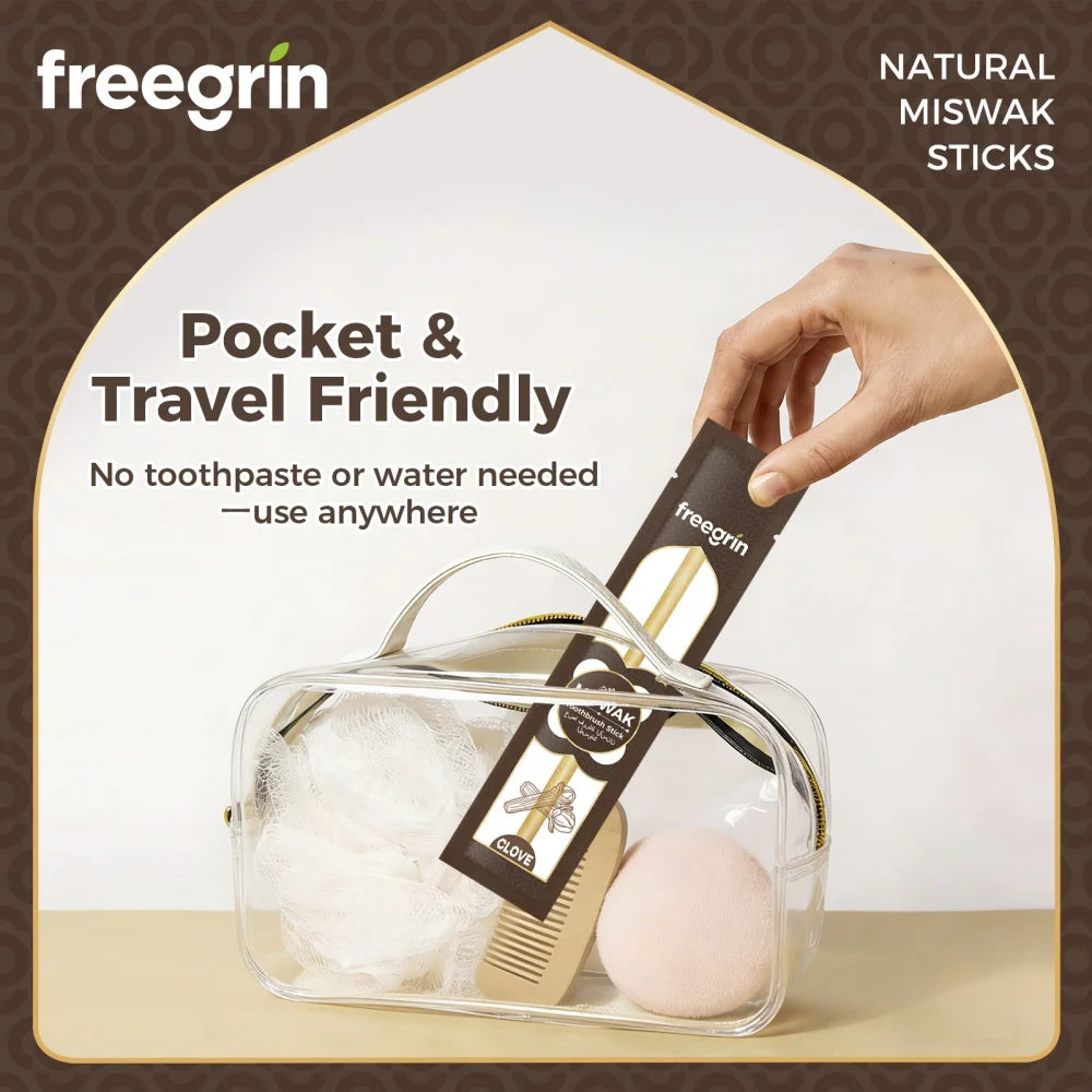 A hand is holding a fregrin natural miswak stick toothbrush inside a clear travel case.