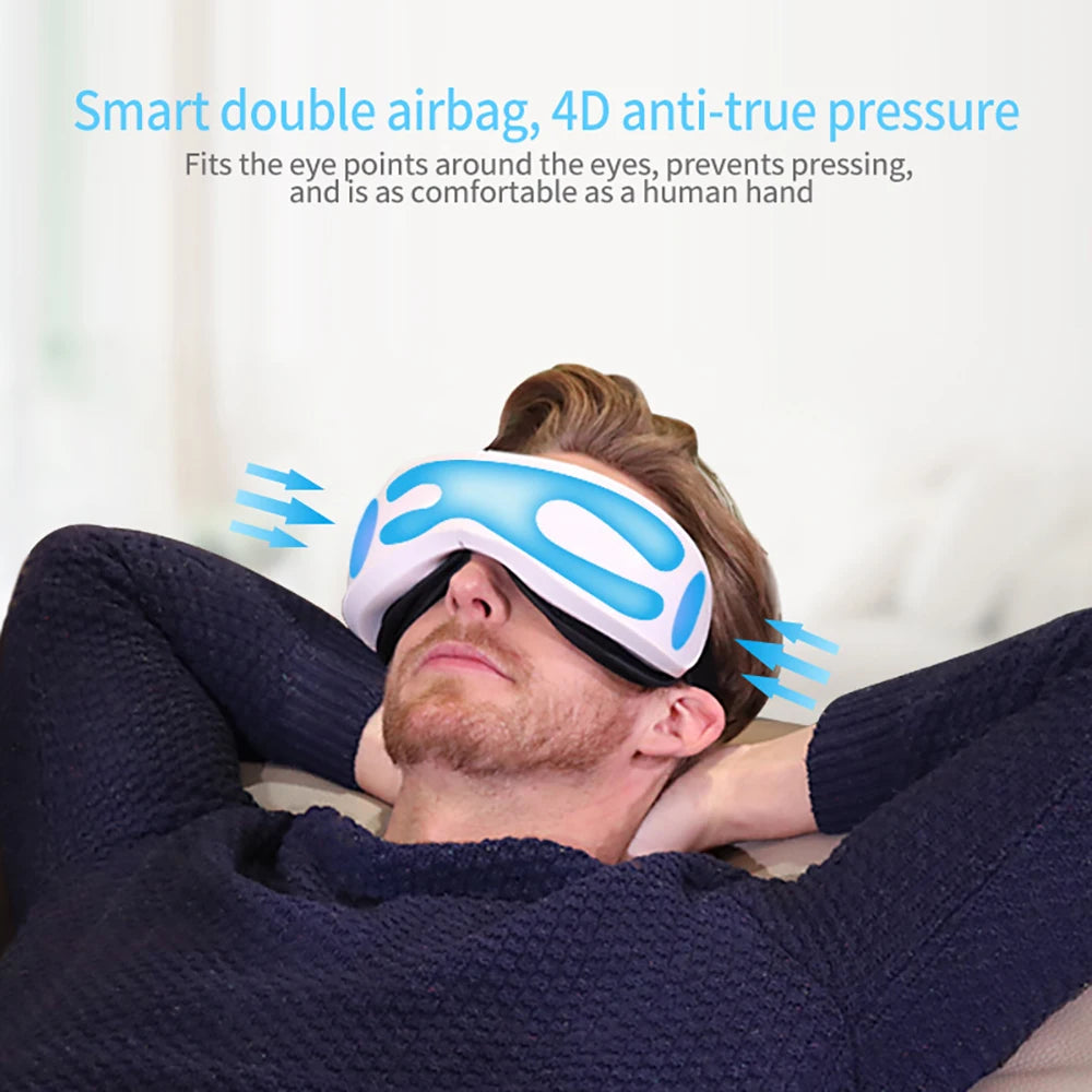 A man is using a blue and white portable Bluetooth eye massager on his eyes.