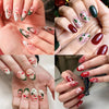 Close-up of hands displaying Christmas Santa Claus 3D nail art stickers with glitter designs on fingernails