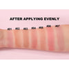 A close-up of a forearm showing seven evenly applied stripes of liquid matte blush color.
