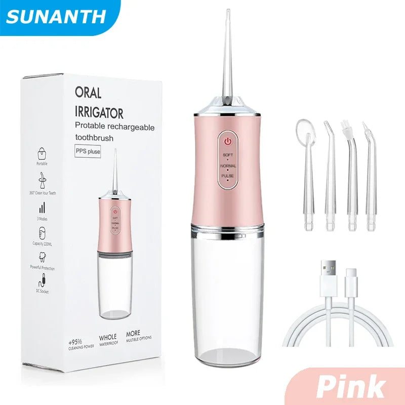 Pink portable rechargeable water flosser with four tips and a storage container.