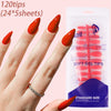 A hand displays bright red acrylic nails and a package of soft gel tips for nail art.