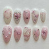A set of 24 pink heart pearl press-on fake nails featuring delicate floral and heart designs.