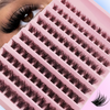 Close-up of a pink lash curler with multiple rows of black false eyelashes and a single lash.