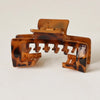 A close-up of a brown leopard print non-slip hat claw clip with a matte finish.