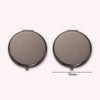 A round, portable folding makeup mirror with a magnifying feature shown from the top.
